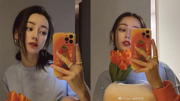 迪丽热巴晒春日对镜自拍 手捧郁金香发丝轻挽慵懒随性